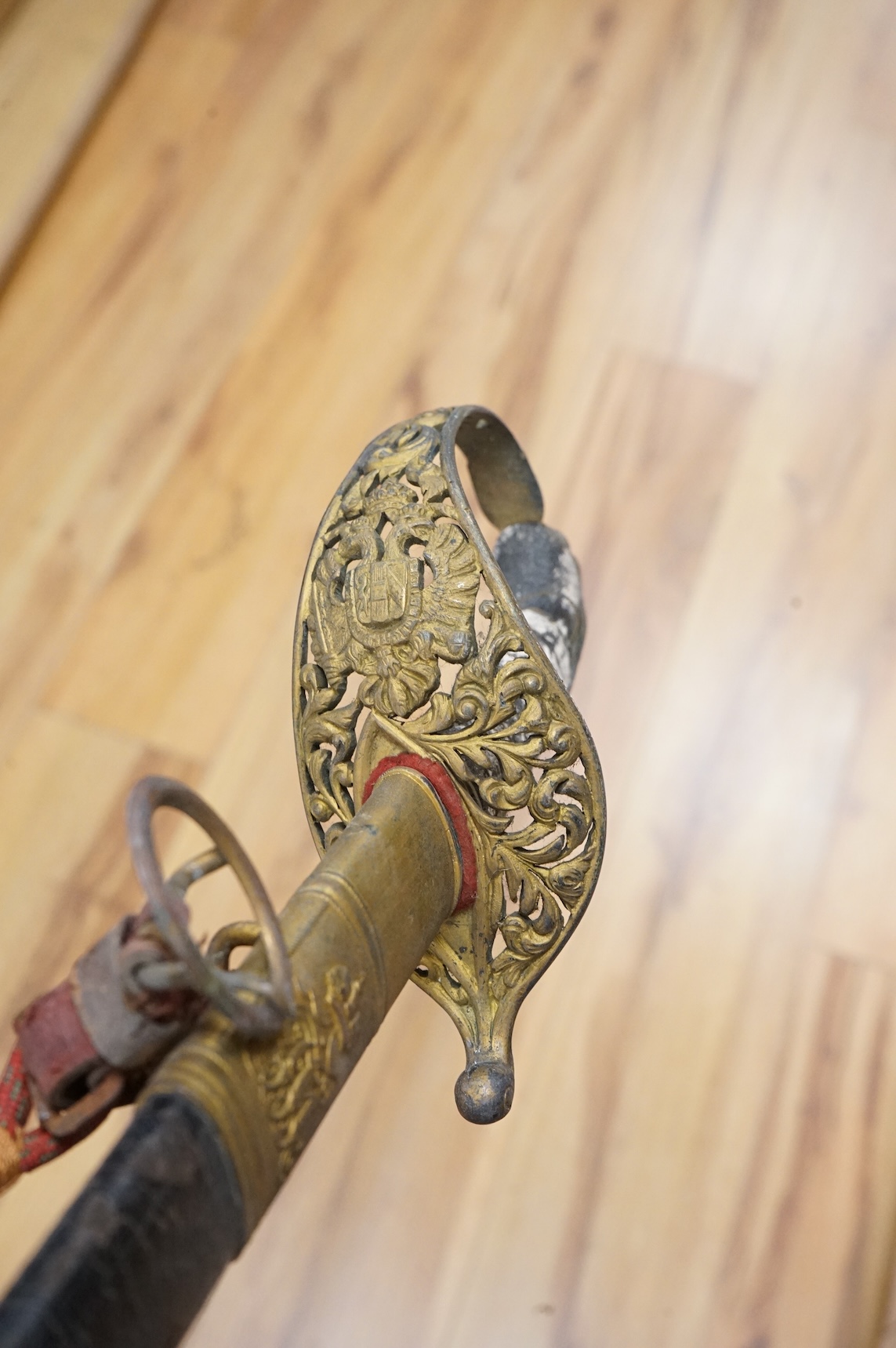 An officer’s sword, three walking sticks and an antique sword stick, longest walking stick 92cm long